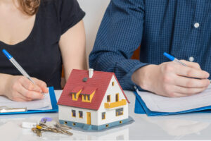 Divorce and dividing a property concept. Man and woman are signing divorce agreement.